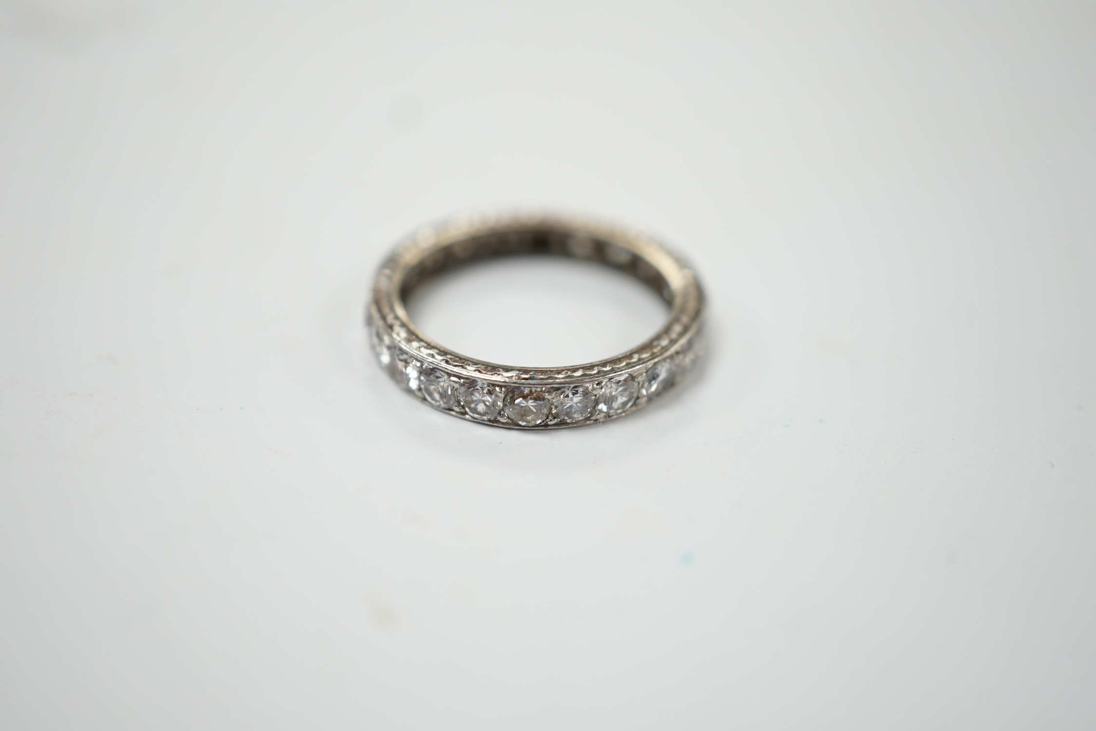 A white metal and diamond set full eternity ring, size L, gross weight 3.1 grams. Fair condition.